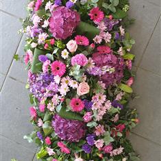 Pink&#39;s and purples coffin spray